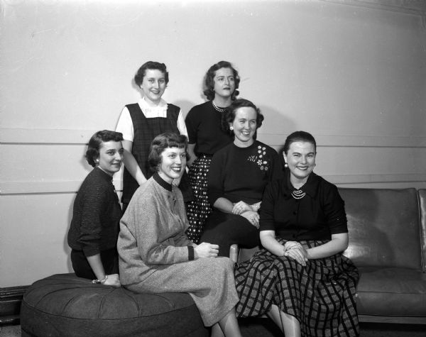 Committee chairmen plan the Edgewood College alumnae association's style show. Seated left to right: Jo Ann Keleny, Marcia Corcoran, Mary Rohowetz, Patricia Butler. Standing left to right: Marilyn Van Wagenen, Beverly Aberg, Betty Jacques, Florence Gately.