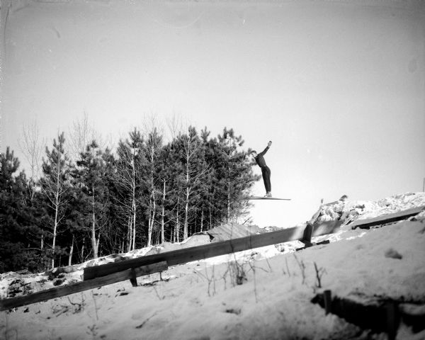 Dick Jacobson of Madison is about to land a ski jump at a Blackhawk Club ski jumping tournament at Tomahawk Ridge, located west of Middleton.