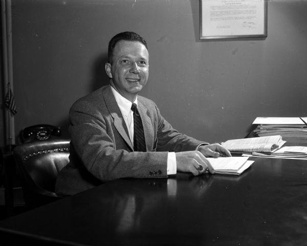 Portrait of bachelor Robert Fish at his desk.