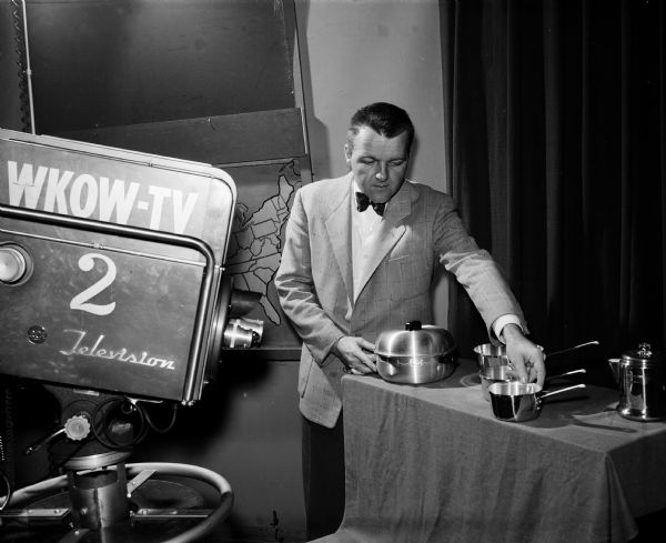 Clark Hogan, operations manager of WKOW-TV, prepares advertising in the television studio.