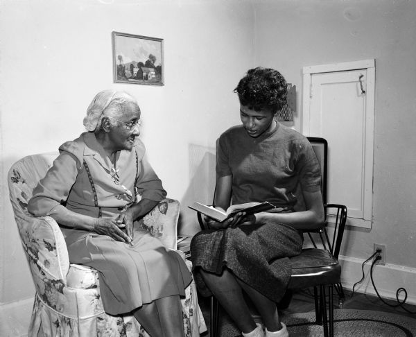 Hazel Hargrove, freshman at Central High School, reads to her blind neighbor, Mrs. L.E. Grandison, as a Lenten expression of concern for others.