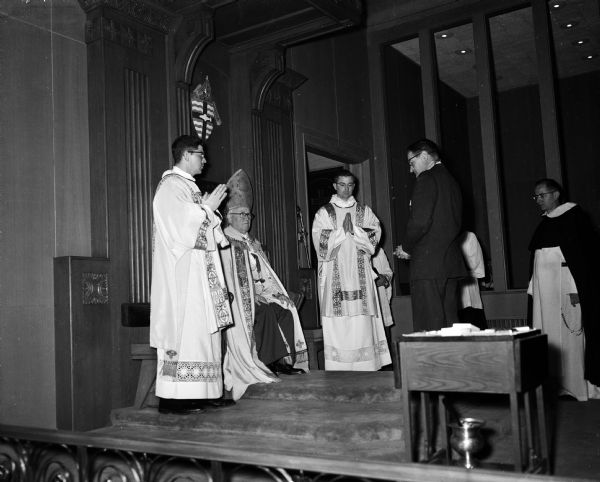 Bernard Gill, right, receives the St. George Award for Scouting at St. Raphael Cathedral. Seated is Bishop William O'Connor. Flanking the Bishop are Reverend Michael Slein and Reverend Francis Kelly.