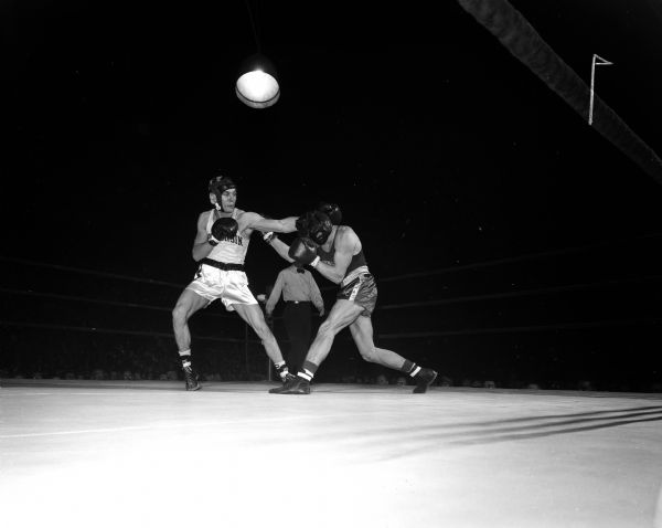 Jim Schneider, the University of Wisconsin's 147-pound boxer, engages in a match with Joe Zeeben of Washington State.