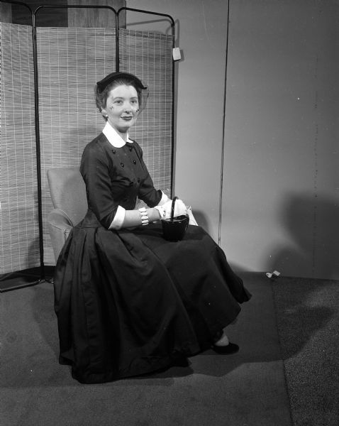 Charlotte Lunsford, representing the Junior Division of the University League, models fashion for the 'smart clubwomen.' The proceeds of the style shows were to maintain and further the services to those with cerebral palsy living in Madison and Wisconsin.