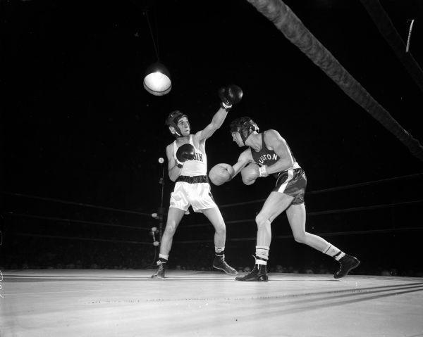 University of Wisconsin boxer Dick Bartman, left, competes against Houston's Alton Allen. Their match ended in a tie.