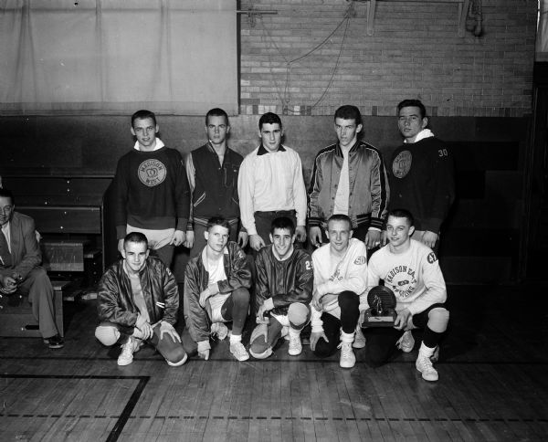 Group portrait of individual champions of the Madison High Schools Sectional Wrestling Meet. Wrestlers include, first row, left to right: Ray Hamel, Wisconsin; Mark Heironimus, Wisconsin; Dave Hamel, Wisconsin; Richard Borchardt; East; and Jim Innis, East. Second row: Jim Hembre, West; Mark Trewartha, West; Ralph Bushnell, West; Bernard Kane, Central; And Karl Holzwarth, West.