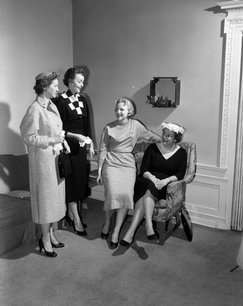 Four women chat at the spring benefit style show and dessert bridge party, sponsored by the Alpha Phi sorority and alumnae. They include, from left: models Florence Herrling and Judy Hake, and chairs of the event, Carol Nemee and Jean Riley.
