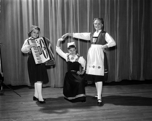 A trio of Girl Scouts from Lapham School's Troop 16 present Norwegian folk song and dance, which will be part of a program featuring many scout groups. Left to right: Kathleen Blandino, Martha Holt, and Jean Schmidt.