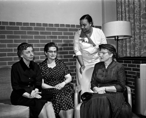 Group portrait of four of the 200 women who attended the Inter-Faith Tea sponsored by the Madison Council of United Church Women. They include, from left: Vera Browne, council first vice-president, Grace Episcopal Church; Esther Allen, corresponding secretary, First University Methodist Church; Mrs William L. Jenkins, historian, St. Paul's Methodist Episcopal Church and Ilma Wallenfeldt, recording secretary, First Congregational Church.