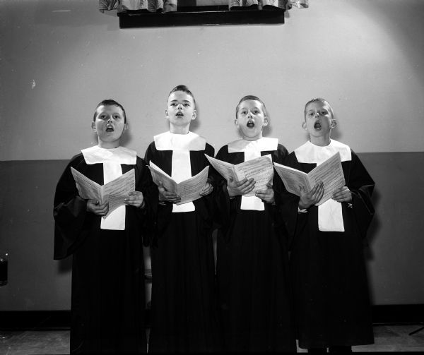Gary Haffner (left), Robert Rennebohm, Robert Monschein, and Stephen Suomi sing in a choir during an Easter service at Luther Memorial Church.