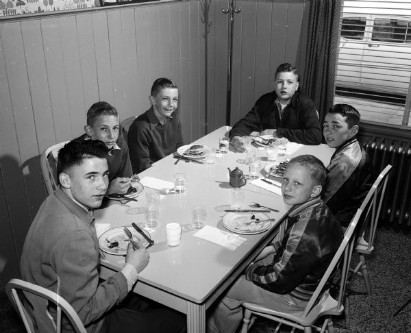 Madison Newspaper carrier boys were treated to breakfast at Felly's Restaurant at 927 South Park Street. Shown clockwise from lower left are: Michael Rieder; Jim Grosse; Bill Grosse; Jim Olson; Mike Sweeney; and John Greisen.