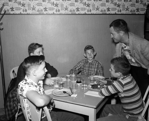 Madison Newspaper carrier boys were treated to breakfast at Felly's Restaurant, 927  South Park Street. Shown seated clockwise are Ivan Hinrichs, James Buchannan, Joe McWilliams, and Bob Hebel. Standing is Charles Mettel.