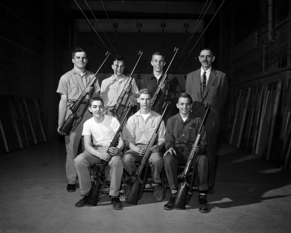 Group portrait of the Fond du Lac Junior Rifle Team, winners of the state junior rifle team championship, at the University of Wisconsin rifle range.