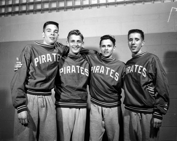 Group portrait of the Port Washington High School two-mile relay team, winners of their event at the annual West High School Relays event. Left to right: Dave Erickson, John Leech, Dick Lehn, and Lynn Robinson.