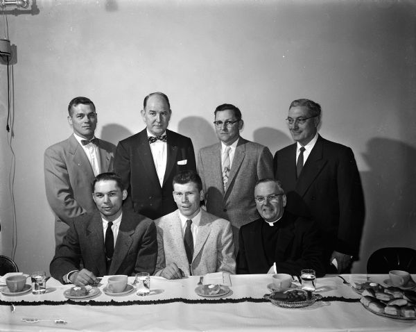 The main speakers at the Middleton High School athletic banquet held at the St. Bernard's parish hall. Seated are: Otto Breitenbach, football coach; Vince Ripp, football and basketball captain; and Rev. Ferdinand Mack, pastor of St. Bernard's church. In back are: Glenn Nording, basketball coach; John Walsh, University of Wisconsin boxing coach; George Staffon, athletic director and baseball coach; and Al Blaschke, banquet chairman and president of the Middleton Civics Club.