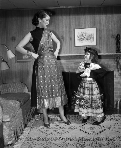 Mrs. Horace Kent (Lucia) Tenney eyes her daughter, Cornelia "Neena," who dresses in a costume prior to the Madison Art Association's Beaux Arts Ball.