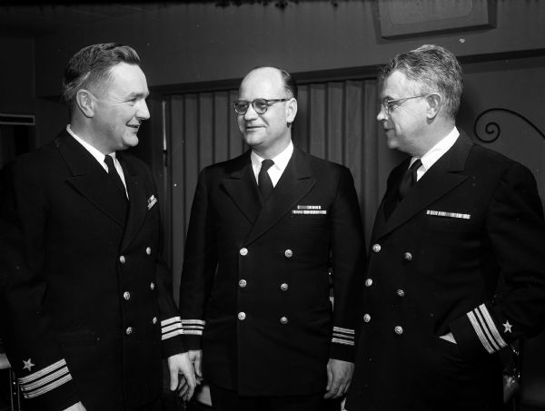 Members of Madison's Naval Reserve Composite Company at the retirement dinner for Captain Reed A. Rose. Left to right: Comdr. Fred Werren, Lt. Comdr. Waldo R. Wold, and Lt. Comdr. Matt Coogan.