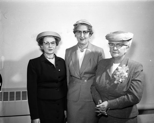 Group portrait of three of the leaders of the second annual convention of the Madison Diocesan Council of Catholic Women held at Our Lady Queen of Peace Catholic Church. Left to right are: Mrs. Harold Lougee of Janesville, recording secretary; Mrs. W.F. (Beradine) Handel, general chairman; and Mrs. Paul (Beatrice) Sergerson, Sr., president of the Madison deanery.