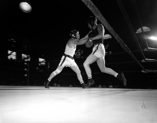 Action photo of Truman Sturdevant of Wisconsin and Jerome Dooling of Detroit in the boxing ring during NCAA tournament heavyweight quarter-finals on Thursday afternoon.