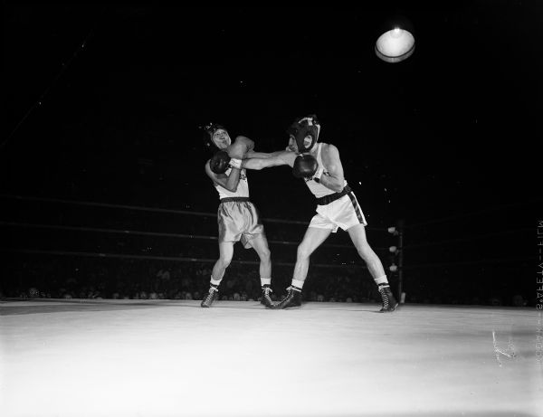 Action photograph of Dean Plemmons of U.W. Wisconsin and T.C. Chung of San Jose State in the ring during their Friday night second round bout.