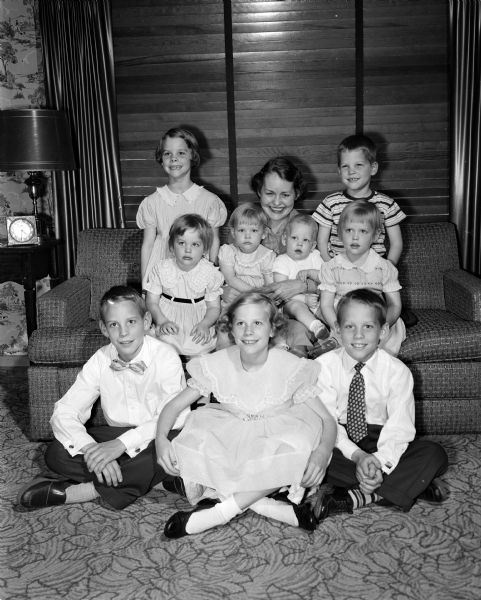 Mother's Day portrait of Margaret Kennedy with her nine children. First row: James (12), Kathleen (10), Joseph (9). Center row: Jeanne (3), Peggy (2), Timothy (11 months), Susan (4). Back row, on either side of their mother, are Mary Beth (7) and Paul (5).
