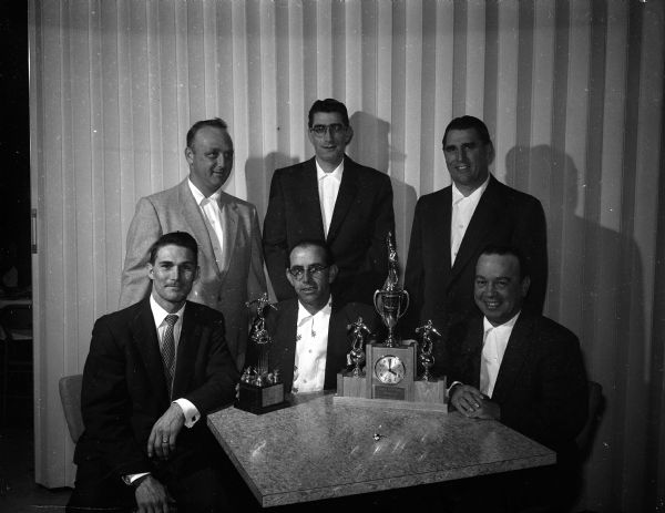 Five members of the Classic Bowling League championship team from Fedele's for Fine Foods posing at the league banquet along with Chuck Medcraft, (seated at left) who was honored by the Madison Bowling Association for rolling a 300 game during the Madison All-Star eliminations. Others seated are: Les Higbie (center) and Joe Fedele. Standing are, left to right: Dan McCarthy, Duke McDaniel, and Russ Langley.
