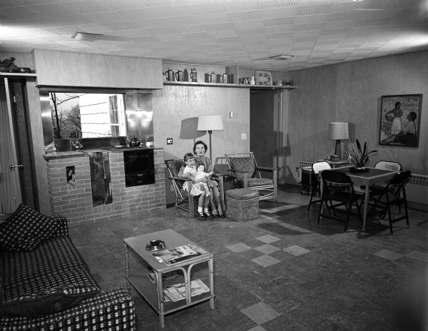 Mrs. William A. (Florence) Tanner sits with her 6-year-old daughter Gail in the new family room addition in their home at 1110 South Midvale Avenue in Madison.