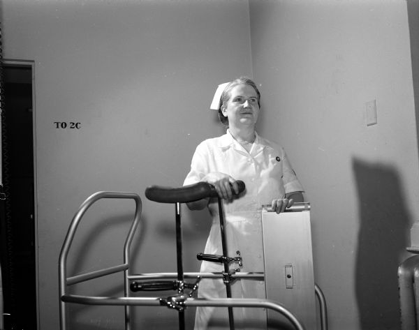 Monnetta Shippy standing next to an assistant device during her job as a practical nurse at University Hospitals. She is also one of the original members of the Philharmonic Chorus, which is celebrating its tenth anniversary.