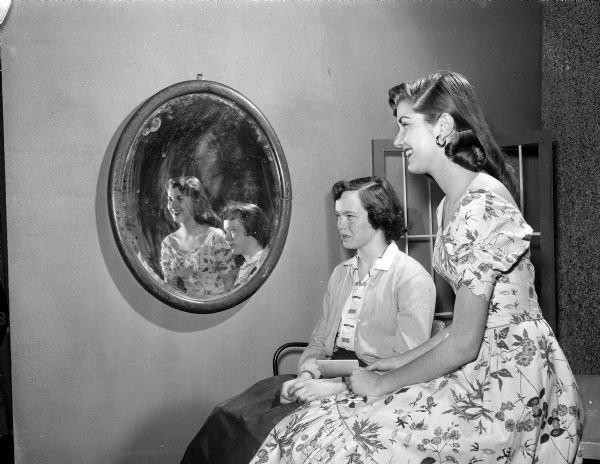 Jane Koberstein and Virginia Burdick are seated and are reflected in a mirror during "Reflections of Youth," a television program on WHA.