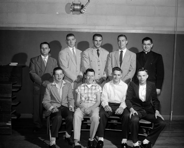 St. Bernard athletes are honored at the school's annual Athletic Banquet. Front row left to right:  Jim Gruendler, Jim Fernan, Terry Thor, Don Hoffman. Speakers at the event shown in back row left to right: Hugo Indra, President of St. Bernard's Athletic Assn.; Everett Chambers, U.W. boxing captain; Lt. Ron Tomsic, U.W. Olympic basketball squad; Pat Levenhagen, U.W. football captain; and Rev. Francis Dominic, St. Bernard's athletic director.