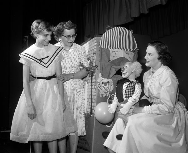 Merrillyn Wegner (Mrs. Robert E.), (right) shows off her puppet "Casper the Clown" to Mrs. Ray (Evelyn) Lessner and her daughter Sharon at the mother-daughter dinner at St. Bernard's Catholic Church.  Merrillyn was known in later life as Lynn Hartridge.