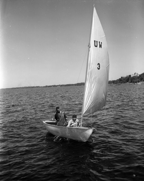 Skipper Pete Barrett of Madison and crew member Ruth Hibbard of Birmingham, Michigan, sail their boat on Lake Mendota. They are one of two University of Wisconsin entries in the upcoming Big 10 Conference sailboat regatta.
