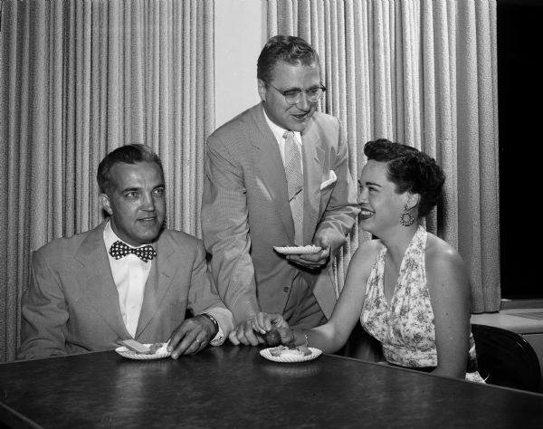Members of the Starlight Dance Club enjoy refreshments at the East Side Business Men's Clubhouse. Left to right: James Bennett, John Parker, and Cecilia Parker.