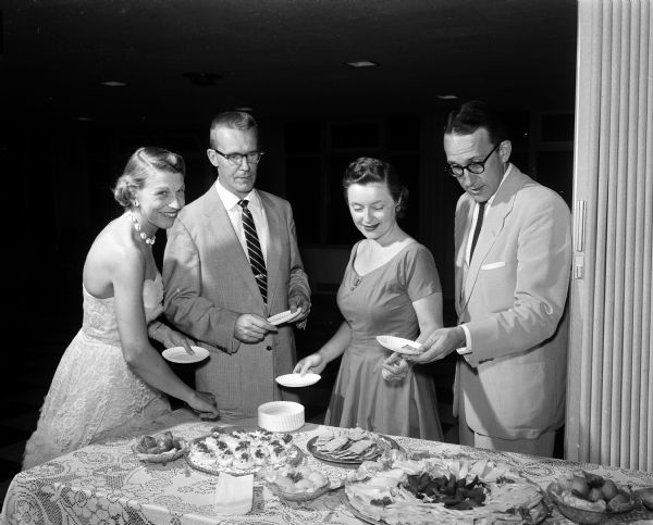 Two couples help themselves to the refreshment table during the Starlight Dancing Club party. Left to right: Elizabeth and Robert Parker, and Shirley and Robert Tottingham.