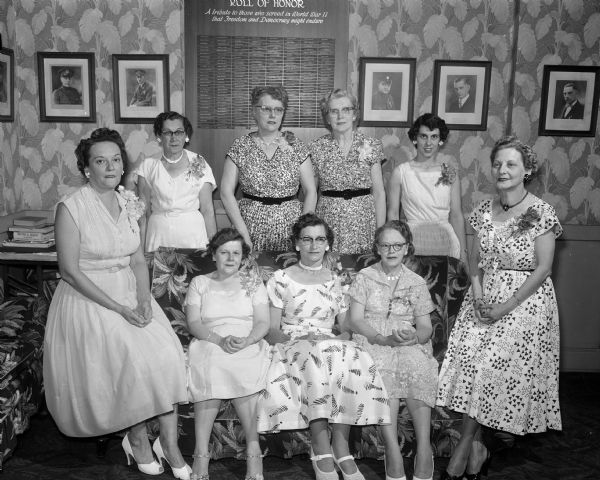 Group portrait of the new officers of the American Legion Auxiliary in the Legion clubhouse. Front row seated left to right: Mrs. Harold Jahnke, Third District vice-president and installing officer; Kay Brahm, secretary; Alvina Bergor, president; Pearl Francisco, first vice-president; and Kathryn Dewey, treasurer. Standing left to right: Lorraine Gerry, sergeant-at-arms; Hazel Lerwick, second vice-president; Anna Fitzpatrick, sergeant-at-arms; and Betty Mead, recording secretary.