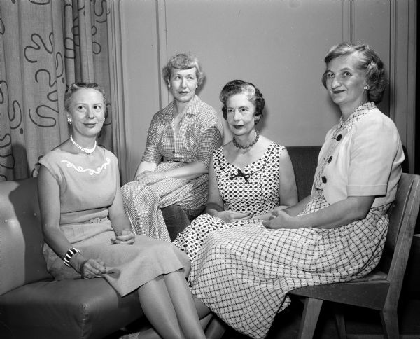 Four Madison women to be initiated into Theta Sigma Phi as associate members are, left to right: Mrs. Albert W. (June) Brown, 1005 Woodward Drive, freelance writer; Mrs. Harold N. (Vivien) Hone, 701 Ridge Street, an editor of the University of Wisconsin News Service; Miss Marion Mills, Lake Mills, copy director for Oscar Mayer and Company and Mrs. Hazel McGrath, 2516 Commonwealth Avenue, also an editor of the University News Service.
