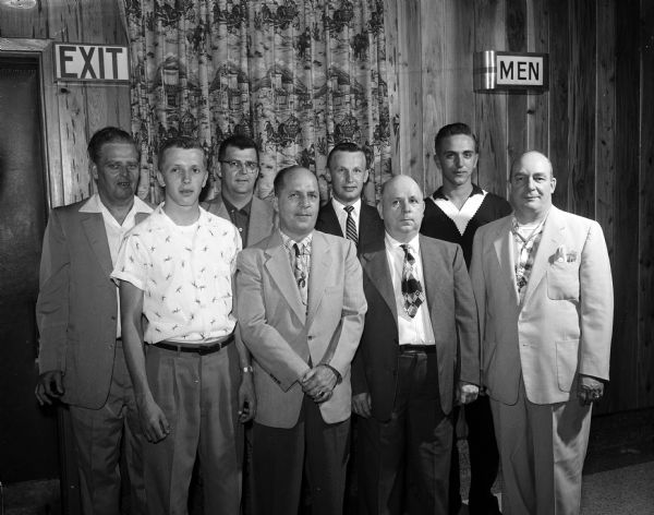Group portrait of the White Cabin Cafe bowling team, honored as the first Madison bowling team to win both the net and handicap championship of the Wisconsin State Bowling Association. Front row left to right: Dewey Grinde, Robert MacBeath, Del MacDonald, Roy  Kippert. Back row: Fritz Siewert, Fred Engelke, Leo Bussan, and Jack Soehnlein.