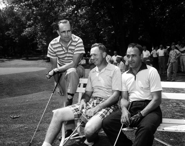 Outdoor group portrait of three of the leaders in the 12th annual Madison city golf tournament at Blackhawk Country Club. Left to right are: Bob Van Etten of Blackhawk, Harry Simonson of Maple Bluff, and Steve Caravello of Nakoma.
