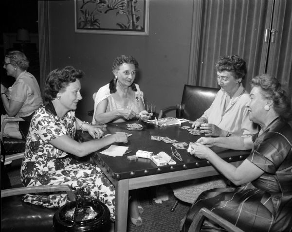Women members of Maple Bluff Country club hold their first Stagette Day with golf prizes. Four of the organizers are shown at a table playing cards. They are, left to right: Evelyn Schroeder, Elizabeth Anderes, Marie Fess Spence, Betty Heath.
