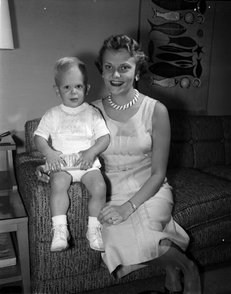 Portrait of Mrs. Daniel A. Peterson with her son Daniel Thomas. They are visiting her parents, Mr. and Mrs. Lowell T. Thronson, and her in-laws, Mr. and Mrs. Basil I. Peterson.