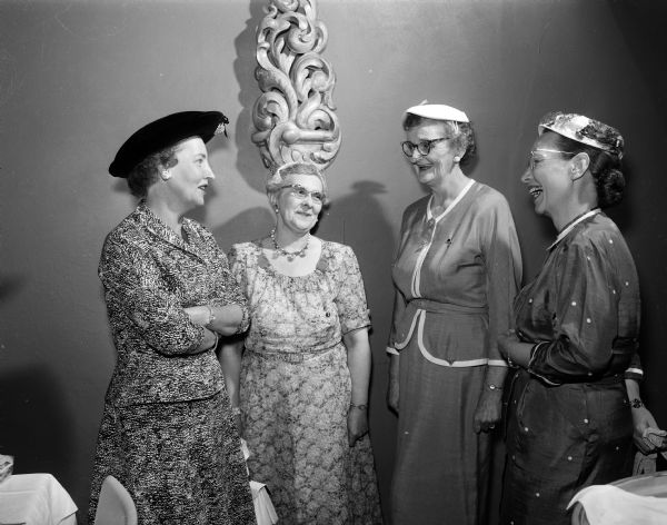Three Madison women greet Elaine Fassold (right), president of the St. Louis chapter at the regional brunch of the American Business Women's Association at the Edgewater Hotel. From the left are Helen Bartle, Helene Blied, and Marguerite Townley.