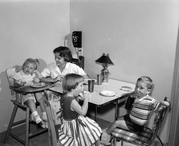 Linda Taylor babysits the three Charlton children: Mary Teresa, 4 years old; Brendan, 3 years old; and Delia, two years old.