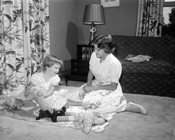 Babysitter Linda Taylor plays a game with Mary Teresa Charlton.