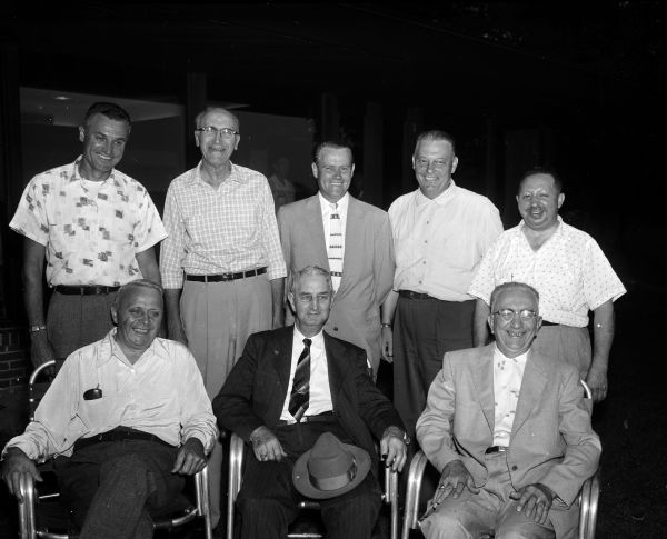 Eight bowling officials are posed at Nakoma Golf Club on the event of the 32nd Madison Bowling Association golf jamboree. Shown seated are: Art Pischke, West Bend,  ABC (American Bowling Congress) first vice-president; William Blau, Madison, ABC past-president; Harold Lampert, Madison, national Elks Bowling Assn. president. Shown standing are: Charlie Allen, Madison, ABC director; Clarence Wertz, Oshkosh, ABC tournament; Ken Hurley, Milwaukee, in charge of ABC rules and regulations; Matt Zwank, Madison, director of Wisconsin Bowling Assn.; and RussAlbers, Madison, MBA president.