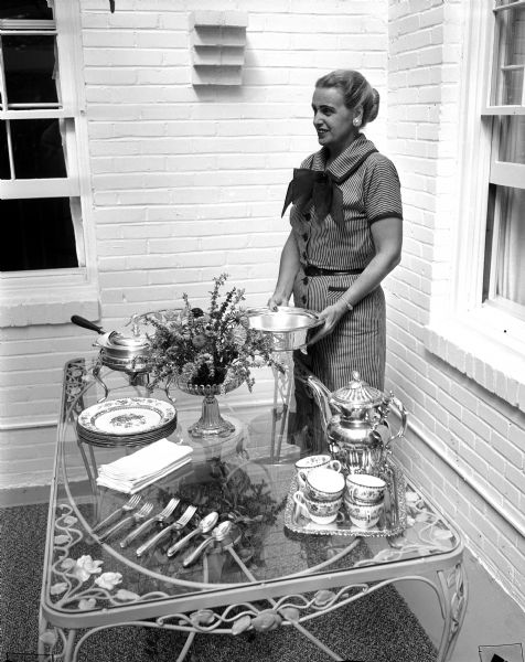 Elizabeth Schlotthauer sets a buffet table on her porch. The photograph was part of a spread for WSJ's Centennial Cookbook recipe contest.