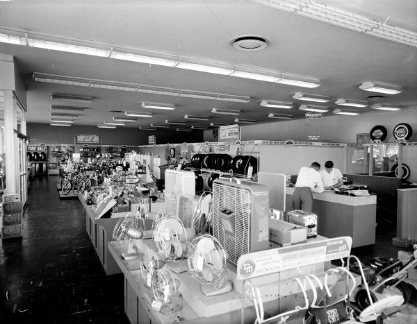 Interior of B.F. Goodrich Company store at 801 East Washington Avenue showing tires, batteries, televisions, and appliances.