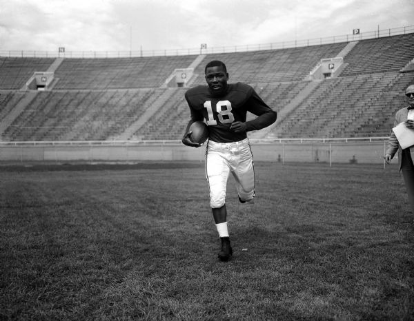 One of thirty five individual portraits of University of Wisconsin football players in action poses.