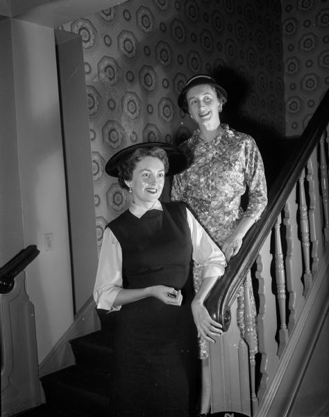 Donna M. Dyson, left, and Elvere M. Evans pose on the stairway at the Maple Bluff Country Club during the Who's New fall luncheon. The club is a YWCA-sponsored organization for new women residents of Madison.