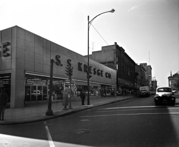 View of East Main Street on the Capitol Square, one of four images making up a panorama of the southeast side of the Capitol Square. The S.S. Kresge Co. building, Capital City Bank building, and the old Vilas Hotel building are pictured.