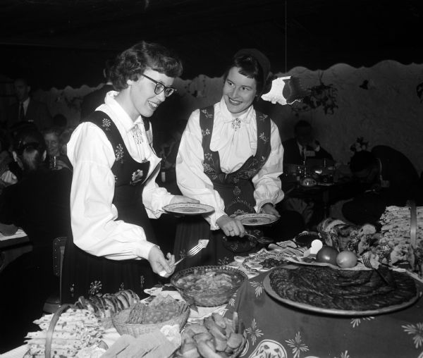 Marie Skramstad (left) and Ann Riiber (right) enjoy the smorgasbord at the UW Scandinavian Club Christmas party.